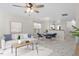 Open-concept living space with white sofa, stylish marble floors, and seamless flow to the dining area at 2248 Ventana Ln, Raleigh, NC 27604