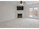 Bright living room featuring a fireplace, marble floors, and french doors leading to a patio at 2248 Ventana Ln, Raleigh, NC 27604