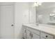 Bright bathroom features white cabinets, quartz countertops, a large mirror, and stylish fixtures at 261 Kissington Way, Benson, NC 27504