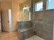 Walk-in shower features tile surround, bench, and glass door at 261 Kissington Way, Benson, NC 27504