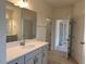 Bathroom with double sinks, vanity, quartz countertop, and framed mirror at 261 Kissington Way, Benson, NC 27504
