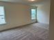 Bedroom with carpet, natural light from a window, and neutral wall color at 261 Kissington Way, Benson, NC 27504