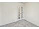 Carpeted room featuring stylish french doors that allow natural light and lead to another room at 261 Kissington Way, Benson, NC 27504
