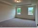 Bedroom with trey ceiling and large windows offering plenty of natural light at 261 Kissington Way, Benson, NC 27504