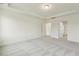 Bright bedroom with tray ceilings, plush carpet, and doorway to another room at 261 Kissington Way, Benson, NC 27504