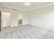 Spacious bedroom featuring plush carpeting, tray ceilings, and ensuite access at 261 Kissington Way, Benson, NC 27504