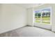 Bright, empty bedroom with large window overlooking the green outdoors at 261 Kissington Way, Benson, NC 27504