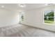 Bright bedroom with carpet floors, two windows and views of backyard at 261 Kissington Way, Benson, NC 27504