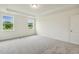 Bright bedroom with tray ceilings, plush carpet, and natural light from two windows at 261 Kissington Way, Benson, NC 27504
