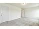 Well-lit bedroom features neutral carpet and a closet and door at 261 Kissington Way, Benson, NC 27504