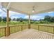 Large wooden deck offering backyard views of lawn and trees, beautiful ceiling fan at 261 Kissington Way, Benson, NC 27504