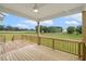 Large wooden deck offering backyard views of lawn and trees, beautiful ceiling fan at 261 Kissington Way, Benson, NC 27504