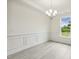The dining room features wide windows, detailed wall trim, and wood-look flooring at 261 Kissington Way, Benson, NC 27504