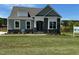 Charming home with stone accents, a landscaped yard, and a welcoming front porch at 261 Kissington Way, Benson, NC 27504