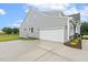 Two-car garage attached to the home's exterior; beautiful landscaping at 261 Kissington Way, Benson, NC 27504