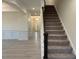 Bright and airy foyer with staircase and view of the front door and entry to other rooms at 261 Kissington Way, Benson, NC 27504