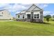 Lovely home showcasing green grass and stone details at 261 Kissington Way, Benson, NC 27504