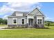 Home with attractive stone facade, green lawn, and 'Available' sign at 261 Kissington Way, Benson, NC 27504