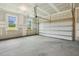 Spacious two car garage showcasing the interior features and natural lighting at 261 Kissington Way, Benson, NC 27504