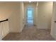 Carpeted upstairs hallway featuring a storage closet and connecting rooms at 261 Kissington Way, Benson, NC 27504