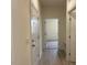 Bright hallway with white trim, neutral walls, wood-look floors and entry to other rooms at 261 Kissington Way, Benson, NC 27504