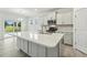 Modern kitchen island with quartz countertop, stainless appliances, and bright, neutral colors at 261 Kissington Way, Benson, NC 27504