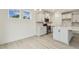 Bright kitchen with stainless steel appliances, white cabinets, island with quartz countertop, and wood floors at 261 Kissington Way, Benson, NC 27504