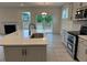 Features an island with a sink, stainless steel appliances, modern cabinets, and hardwood floors at 261 Kissington Way, Benson, NC 27504