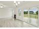 Bright living room with fireplace, ceiling fan, wood floors and sliding glass doors to outdoor deck at 261 Kissington Way, Benson, NC 27504
