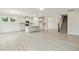 Open-concept living room and kitchen features an island, stainless appliances, and staircase at 261 Kissington Way, Benson, NC 27504