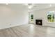 Bright living room with fireplace, ceiling fan, wood floors and views of backyard at 261 Kissington Way, Benson, NC 27504