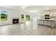 Open-concept living room and kitchen features a fireplace and stainless appliances at 261 Kissington Way, Benson, NC 27504