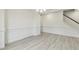 Spacious living room features stairs, white wall trim, hard surface flooring, and recessed lighting at 261 Kissington Way, Benson, NC 27504