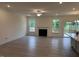 Spacious living room with a fireplace, large windows, and a sliding door to the outside at 261 Kissington Way, Benson, NC 27504