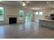 Bright, open living room featuring a fireplace, access to a patio, and a combined kitchen area at 261 Kissington Way, Benson, NC 27504