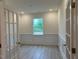 Bright office space with wood-look floors, white trim, and elegant glass doors to the hallway at 261 Kissington Way, Benson, NC 27504