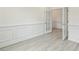Well-lit room with decorative trim and gray floors leading to glass paneled doors at 261 Kissington Way, Benson, NC 27504