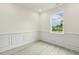 Bright room with white trim, gray floors, and large window offering scenic views at 261 Kissington Way, Benson, NC 27504