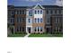 Charming townhome showcasing a brick and siding exterior with well-manicured landscaping at 303 Chesapeake Cmns St # 99, Garner, NC 27529