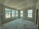 Unfinished living room boasts several windows allowing lots of natural light, with a view of neighboring homes at 303 Chesapeake Cmns St # 99, Garner, NC 27529