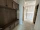 Mudroom shows cubbies, coat hooks, bench seating, and storage; room is unfinished, with the walls still awaiting finishing at 303 Chesapeake Cmns St # 99, Garner, NC 27529