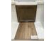 A cabinetry sample paired with luxury vinyl flooring samples for a coordinated interior finish at 303 Chesapeake Cmns St # 99, Garner, NC 27529