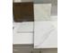 Samples of tile, countertops, and cabinetry with a modern design and neutral color palette at 303 Chesapeake Cmns St # 99, Garner, NC 27529