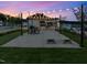 Twilight view of a community pavilion with string lights, picnic tables, and space for neighborhood gatherings at 303 Chesapeake Commons St # 99, Garner, NC 27529