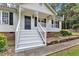 Inviting front porch with white railings and black door, enhancing the home's curb appeal at 308 Deep Creek Dr, Clayton, NC 27520