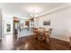 Kitchen and dining area with hardwood floors, an island, and modern appliances at 360 Skymont Dr, Holly Springs, NC 27540