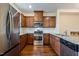 Modern kitchen with stainless steel appliances and granite countertops at 360 Skymont Dr, Holly Springs, NC 27540