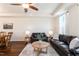 Living room with two leather sofas, coffee table, hardwood floors, and large windows at 360 Skymont Dr, Holly Springs, NC 27540