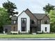 Modern two-story home with a mix of brick and wood siding, a large garage, and landscaping at 3705 Joyful Creek Trl, Zebulon, NC 27597