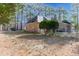 View of the brick home with a fenced backyard lined with trees at 4701 Regalwood Dr, Raleigh, NC 27613